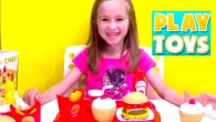 Little girls plays with  kitchen burger toy set